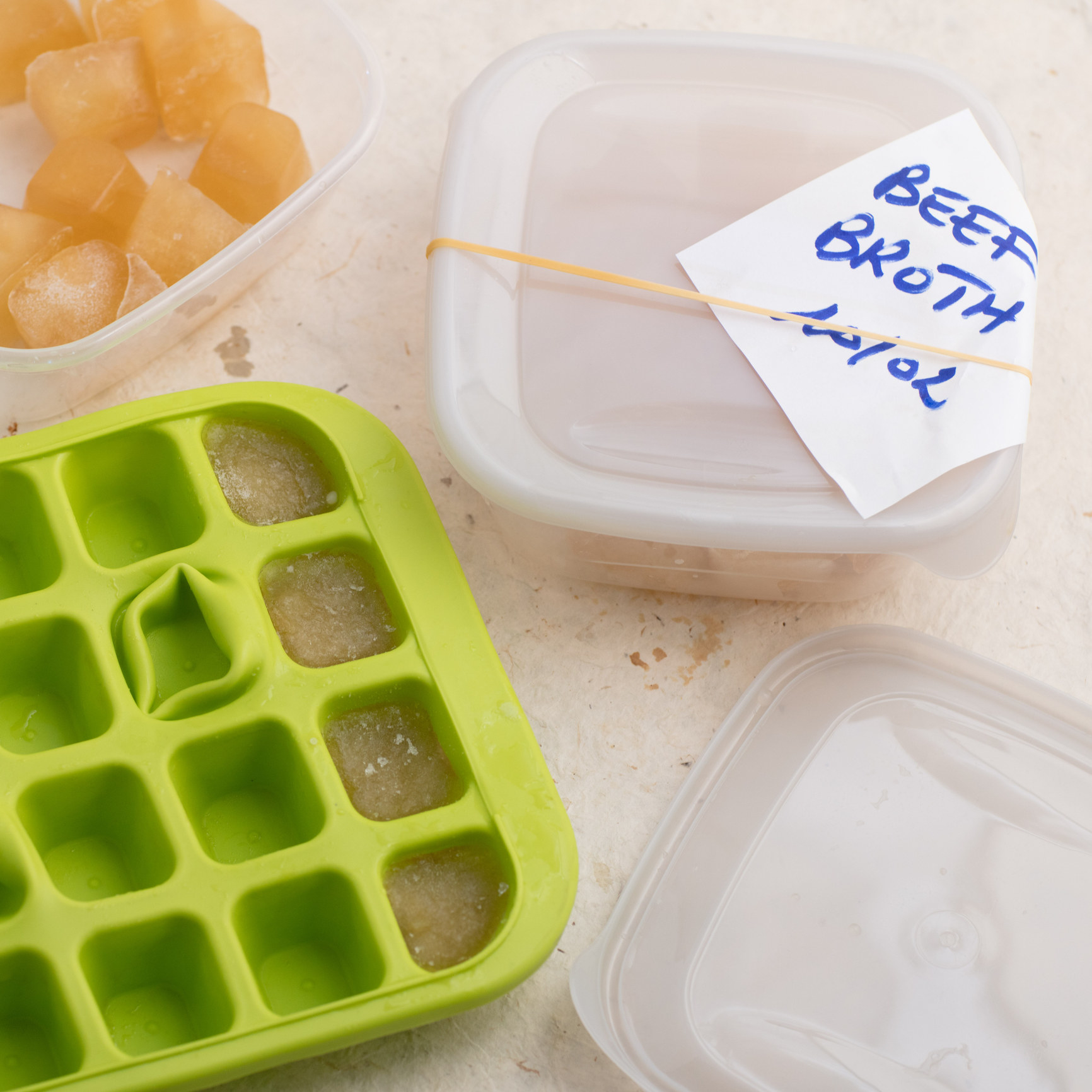 An ice cube tray with soup broth to be frozen for later