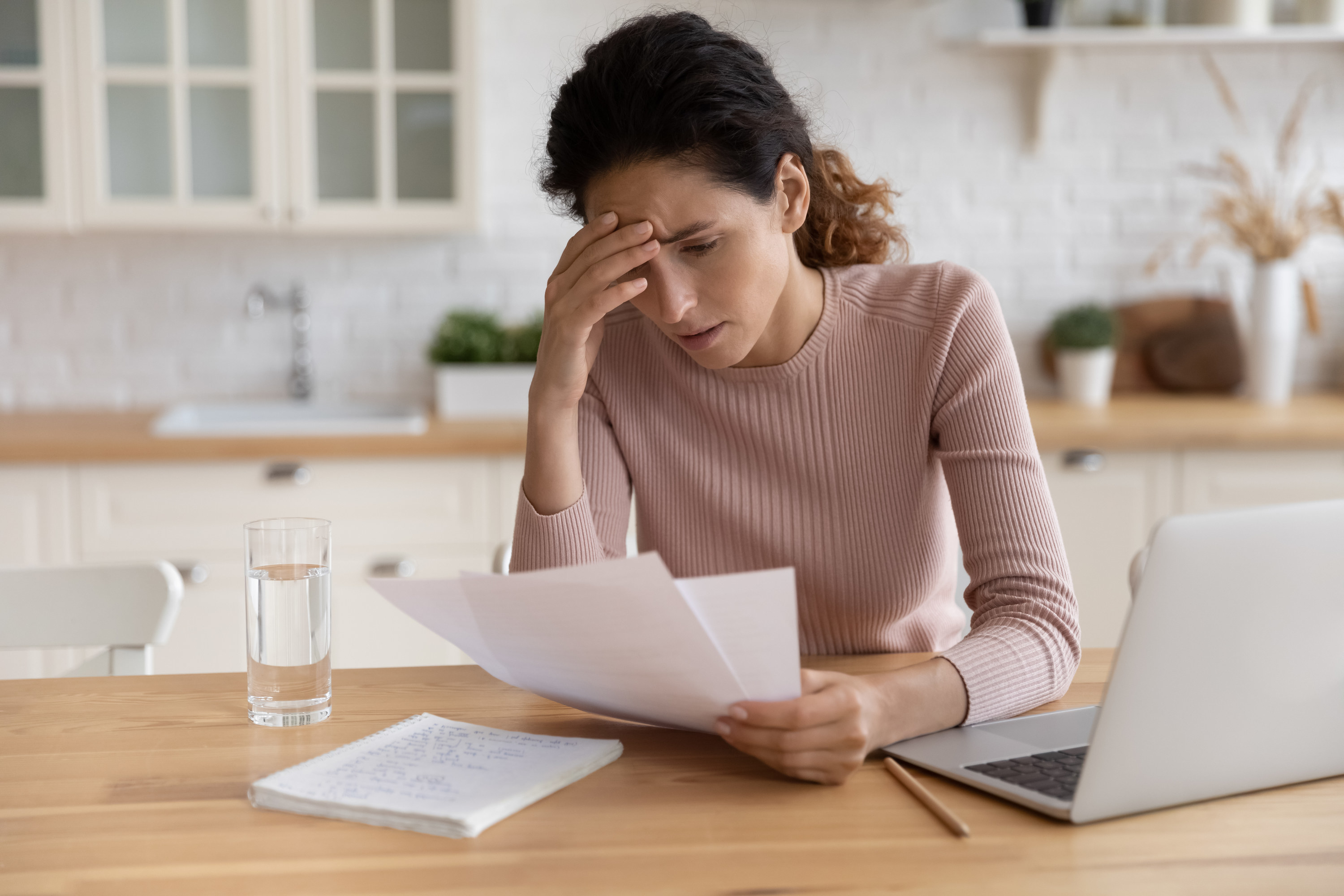 stressed out woman looking at medical bills