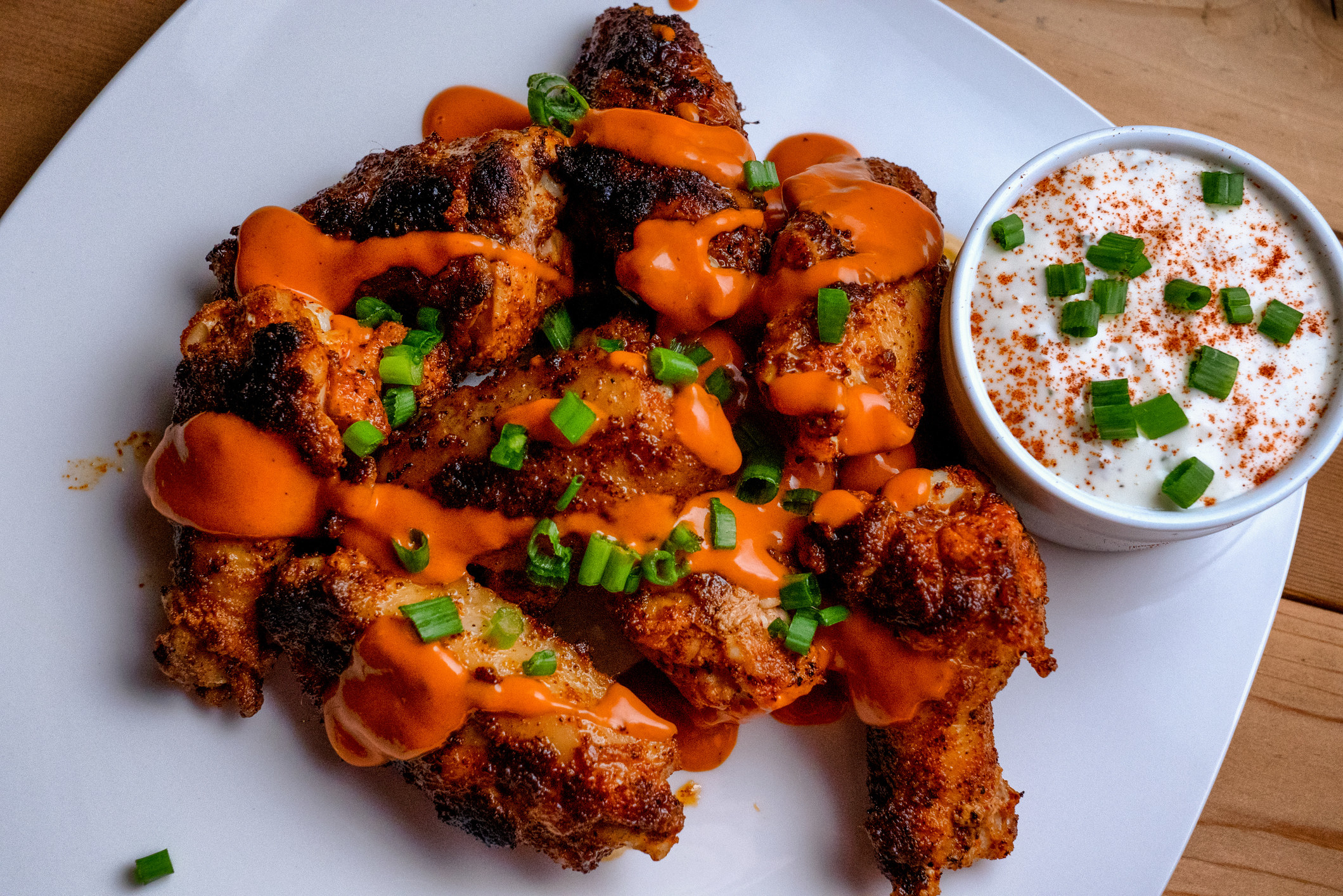 Plate of buffalo chicken wings with ranch dressing