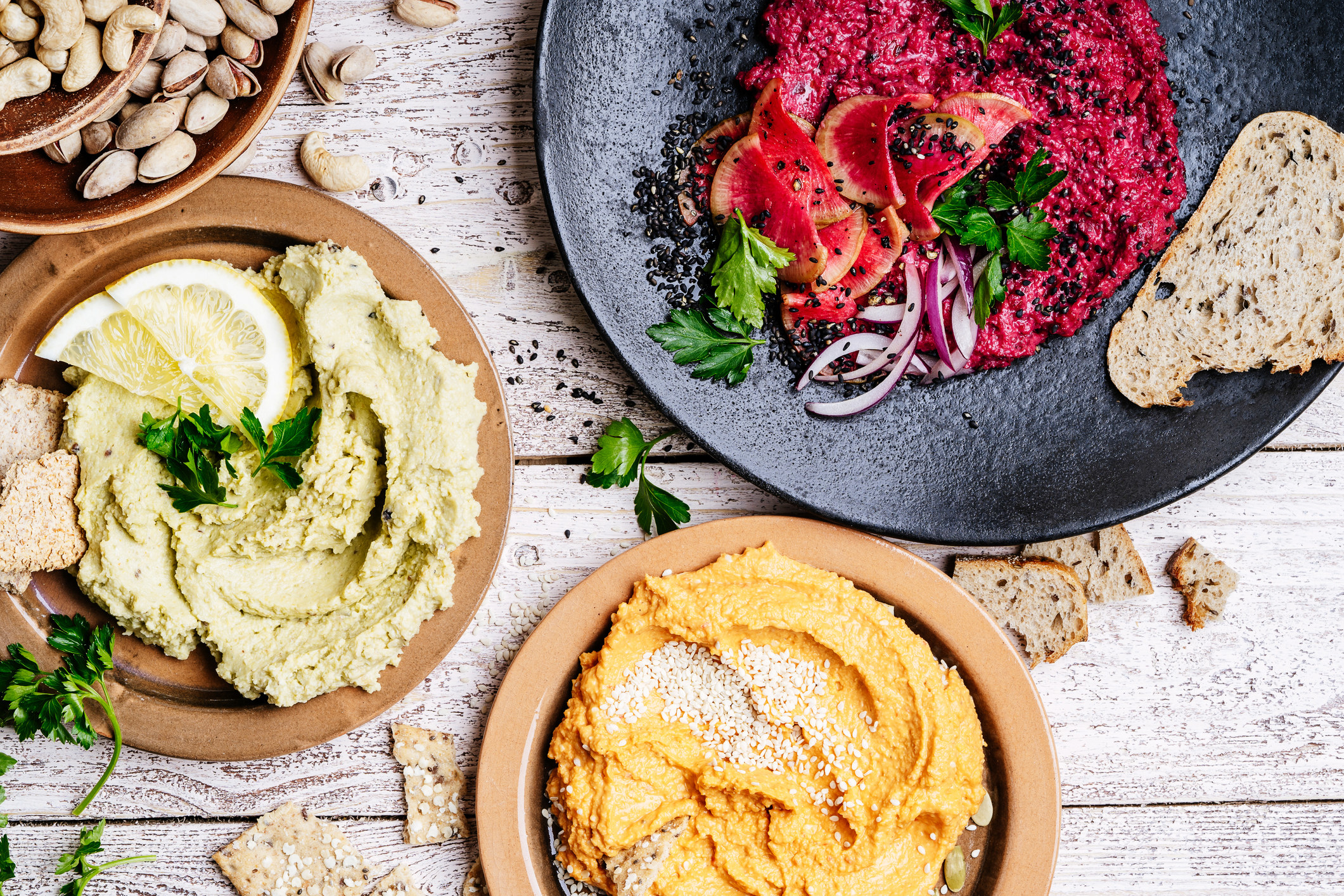 Different flavors of hummus in bowls
