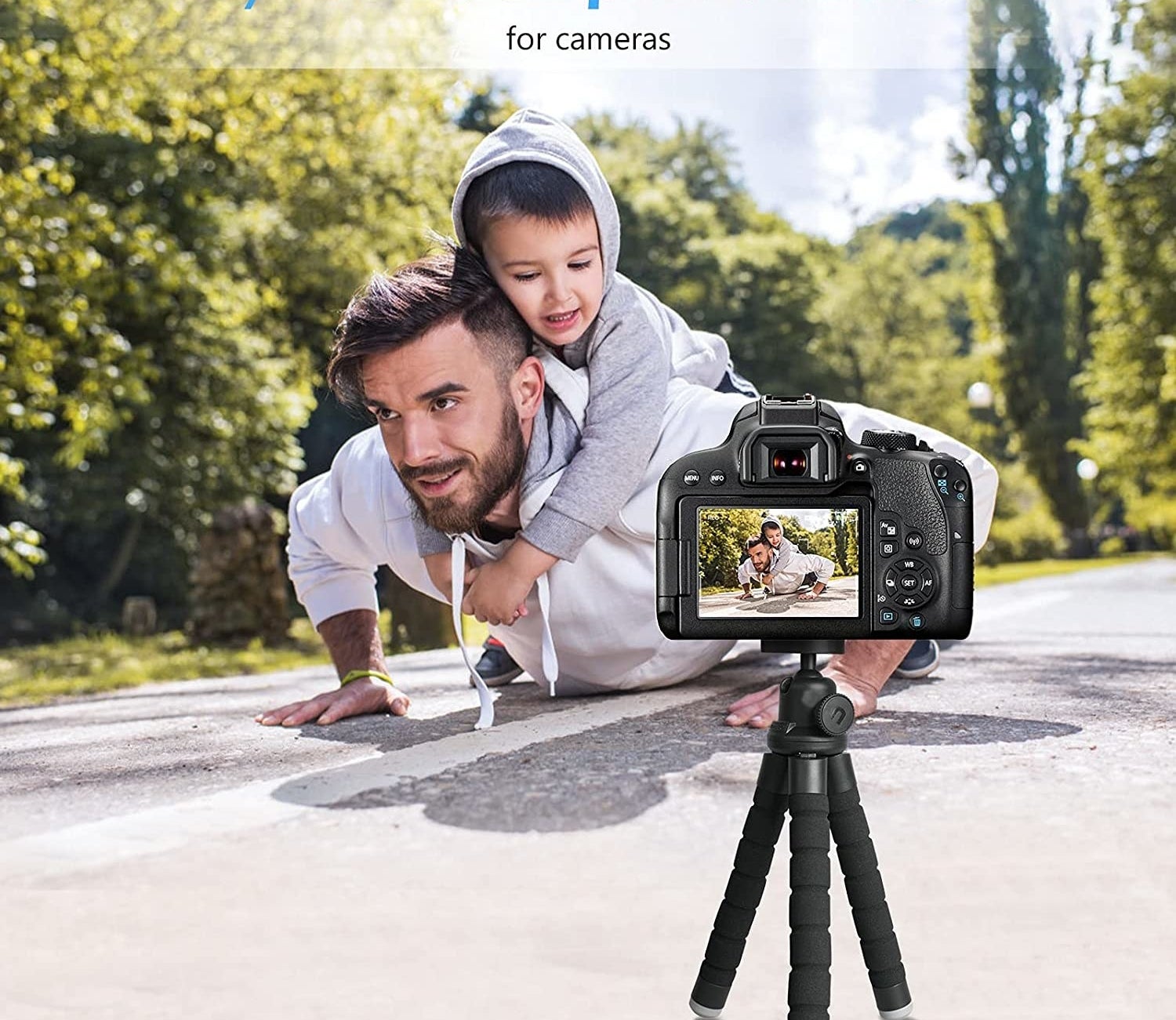person with their child on their back taking a video with the tripod
