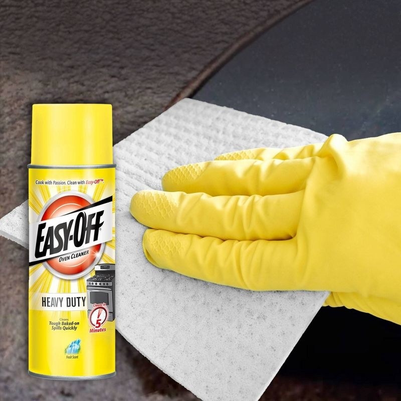 a yellow bottle of Easy-Off oven cleaner and a hand cleaning an oven