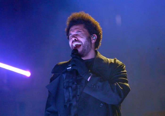 The Weeknd singing onstage with eyes closed