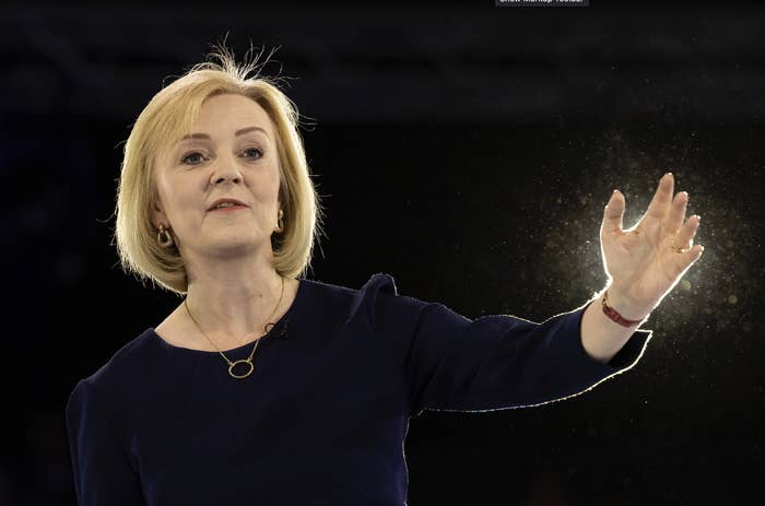 Liz Truss with her arm raised