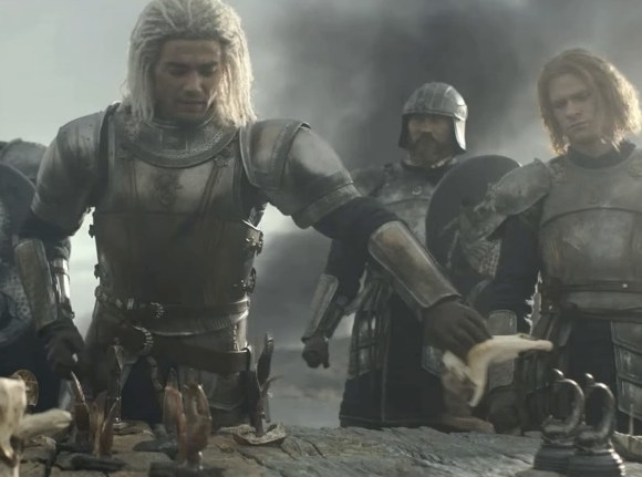 Laenor stands besides Joffrey and another soldier, they all wear armor