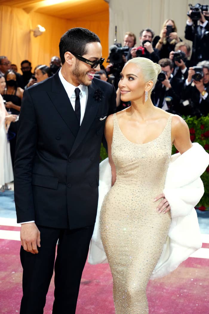 Pete and Kim smiling at each other at the Met Gala