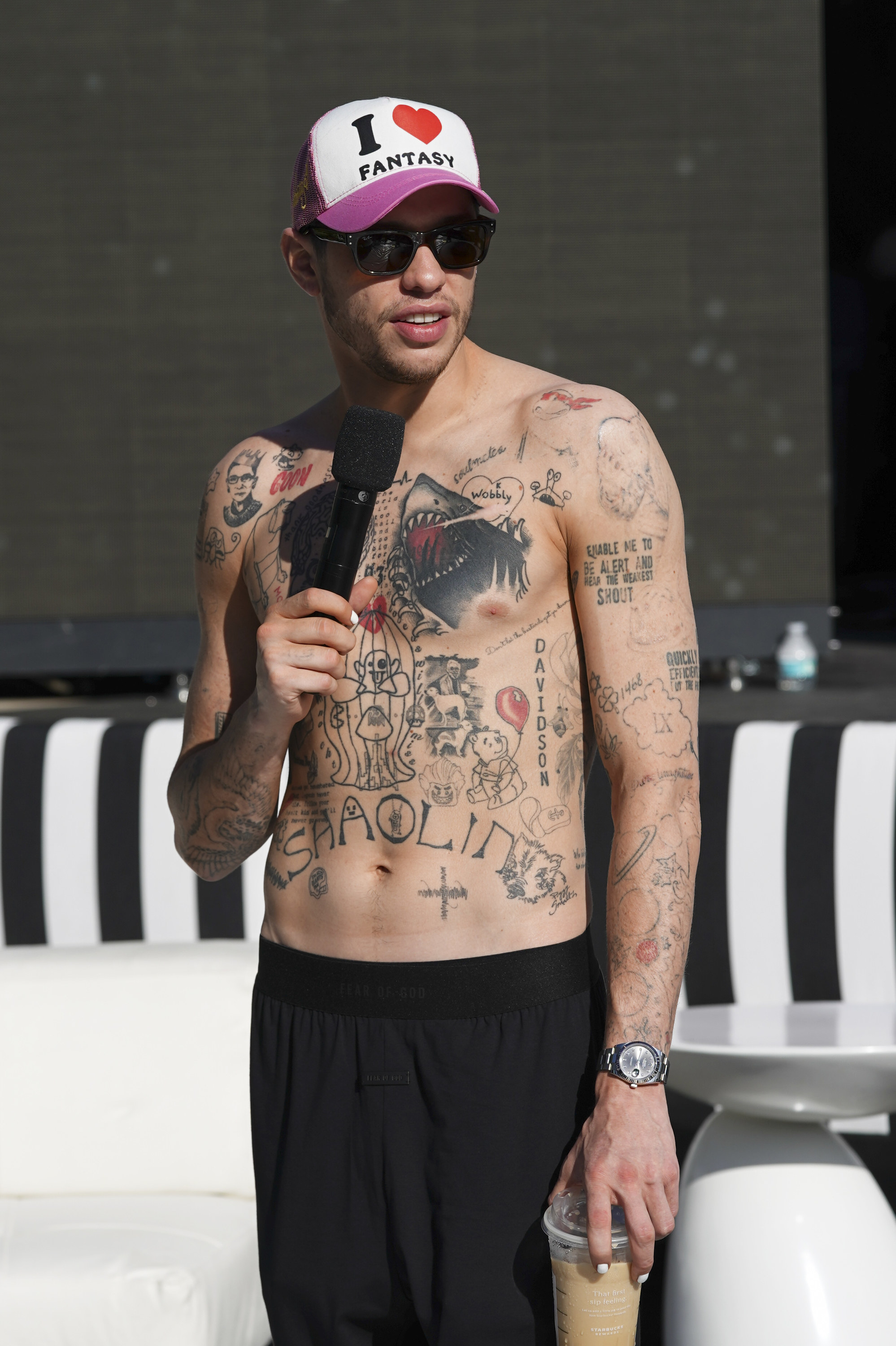 A bare-chested Pete with many tattoos