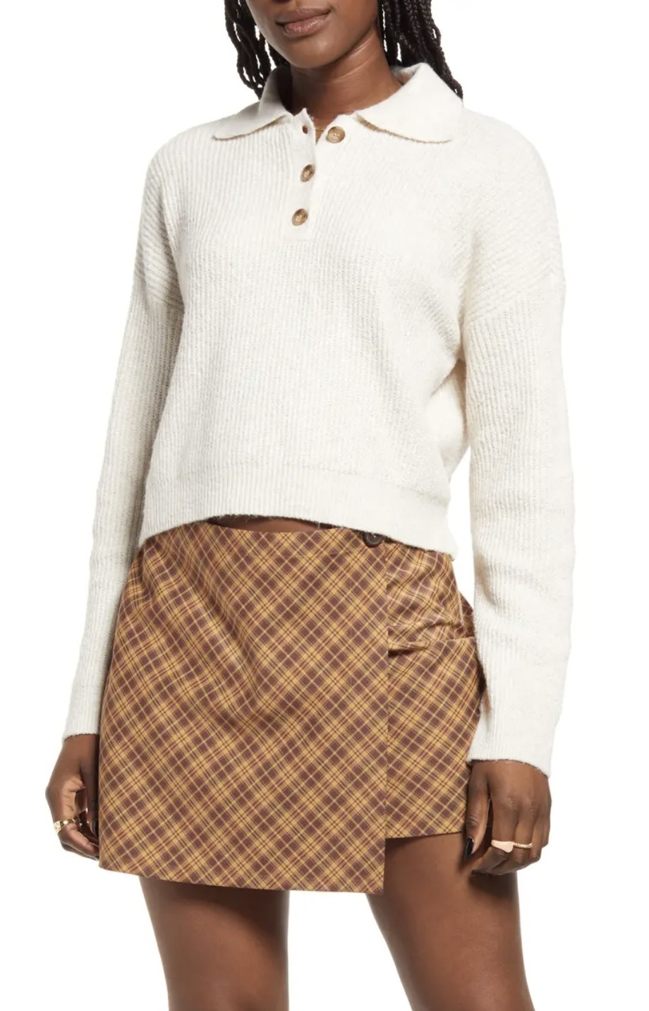 model wearing the white sweater with plaid skirt