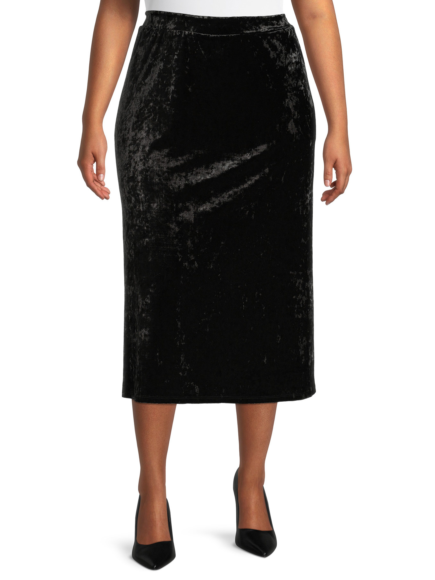 Model wearing crushed-velvet black midi skirt with black pumps