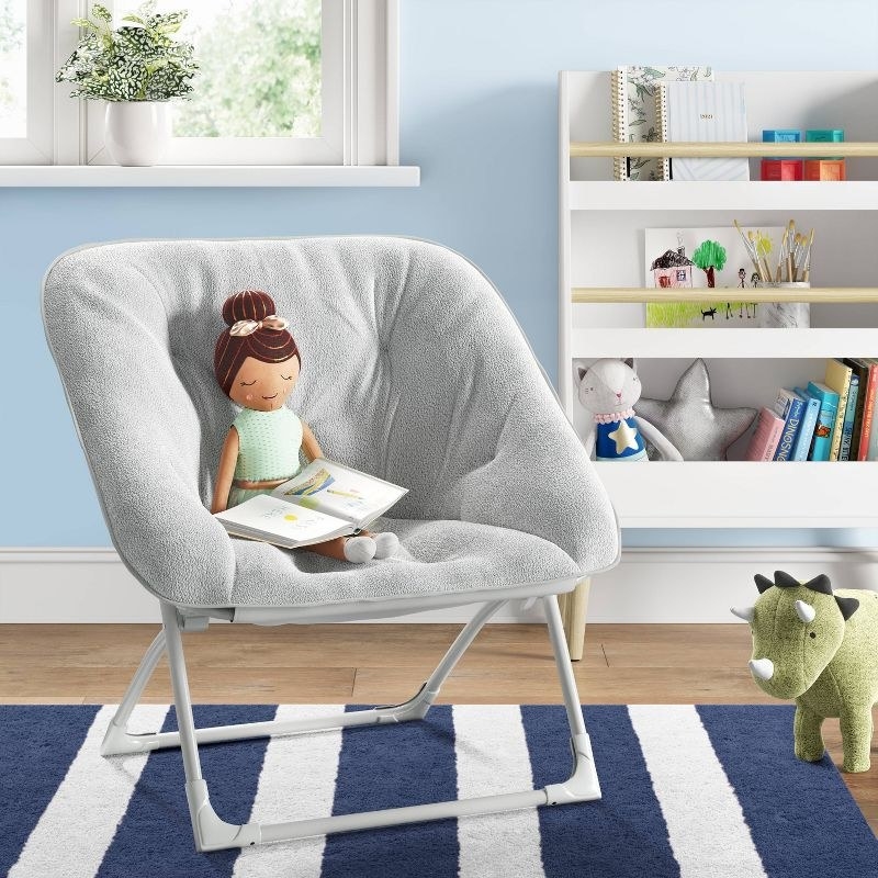 The chair in grey with a doll in it