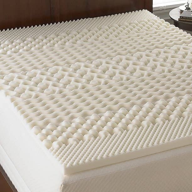 The cream mattress pad has various shapes and contours