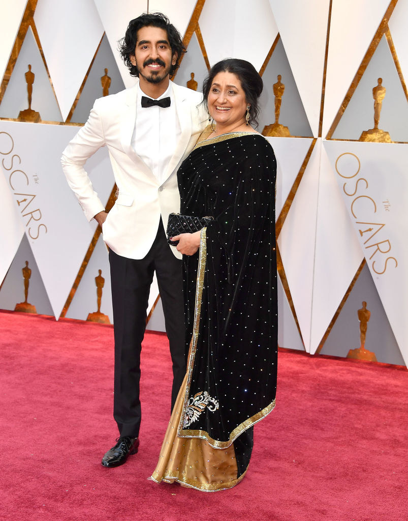 Dev in a bow tie on the red carpet with his mom