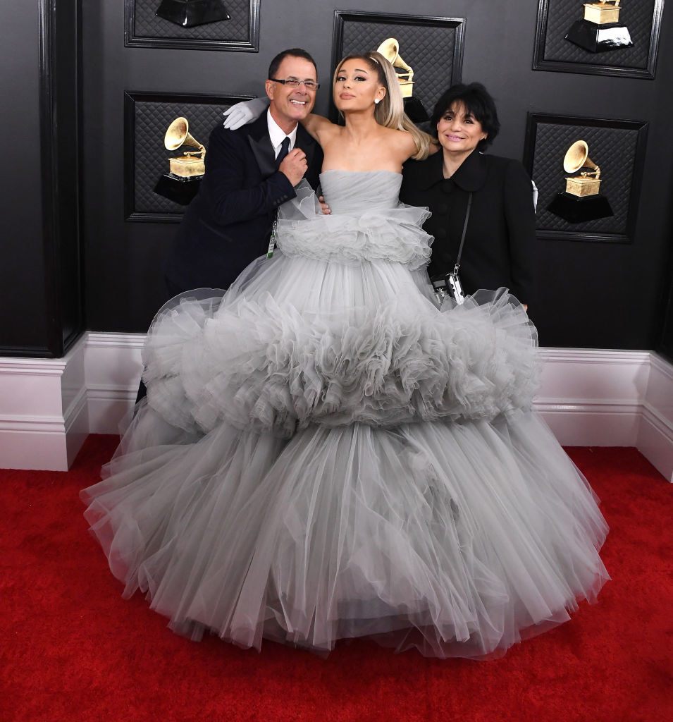 Ariana in a ballerina tiered gown on the red carpet with her parents