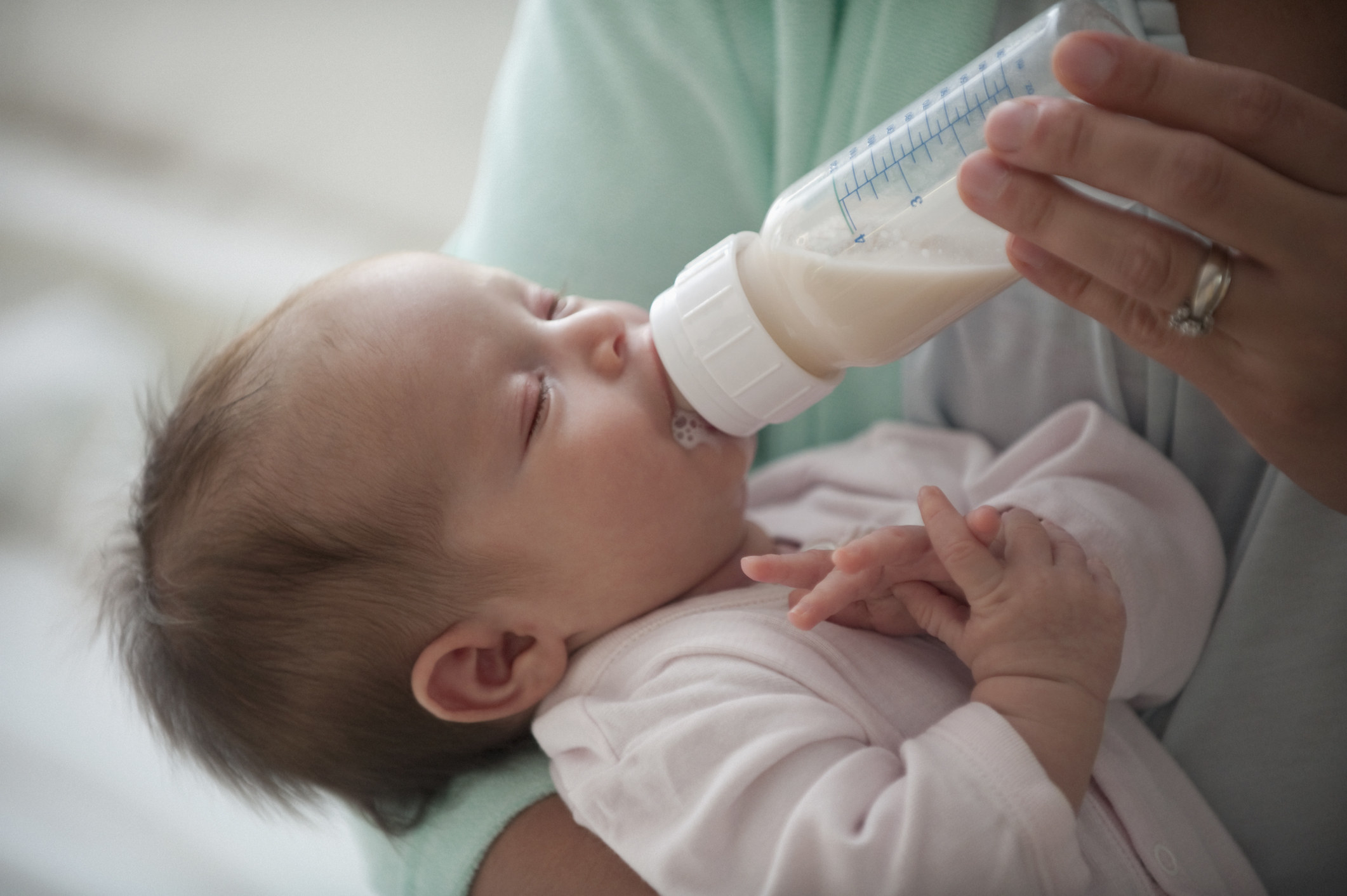 baby being fed with a bottle