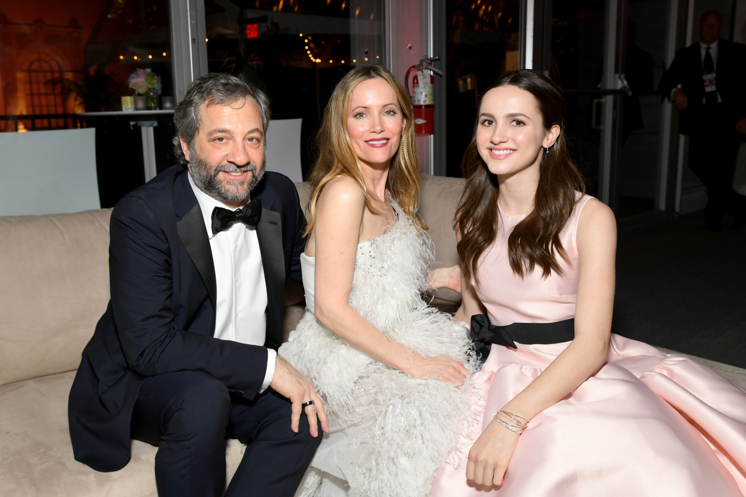 Maude smiling and sitting with her parents