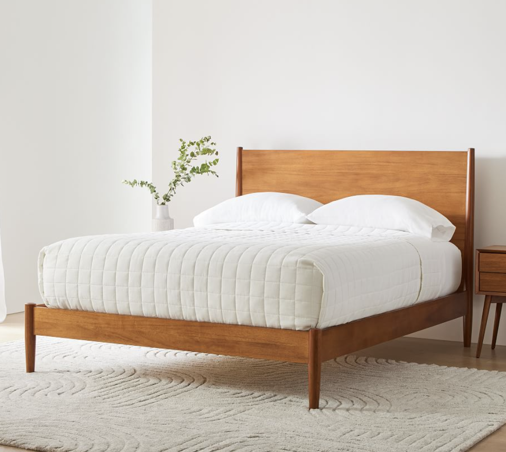 mid-century bed frame in acorn with white bedding