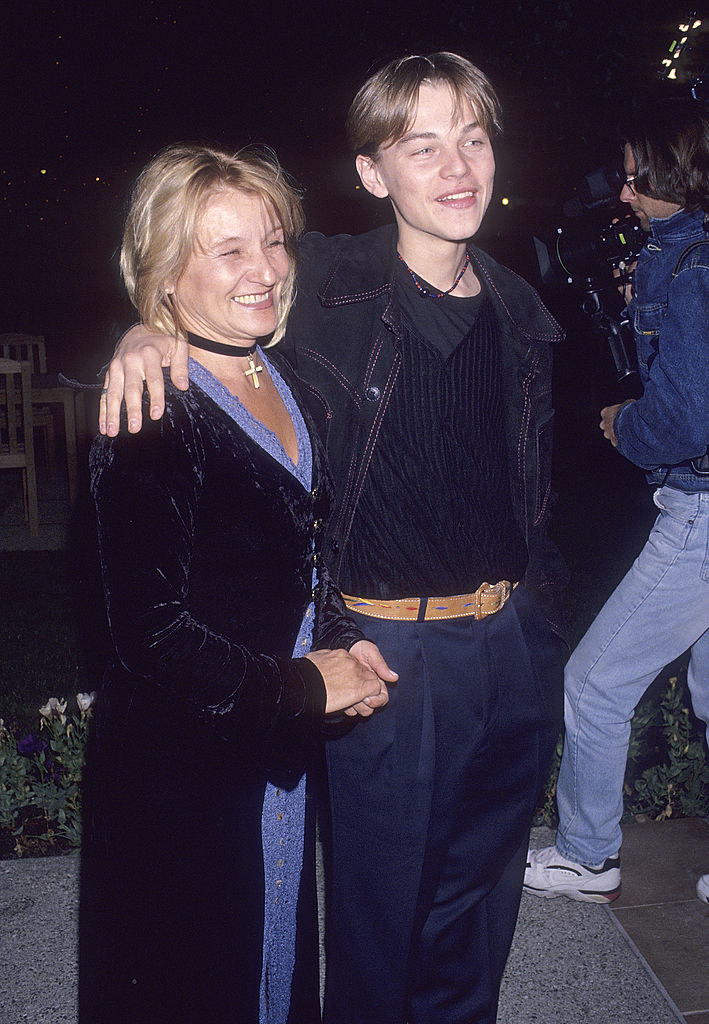 Leo with his arm around his mom&#x27;s shoulders