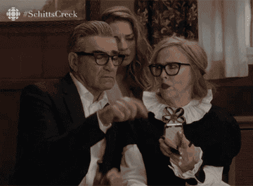 Johnny from Schitt&#x27;s Creek pointing at a phone and saying &quot;Which way do you swipe to get rid of this one?&quot;