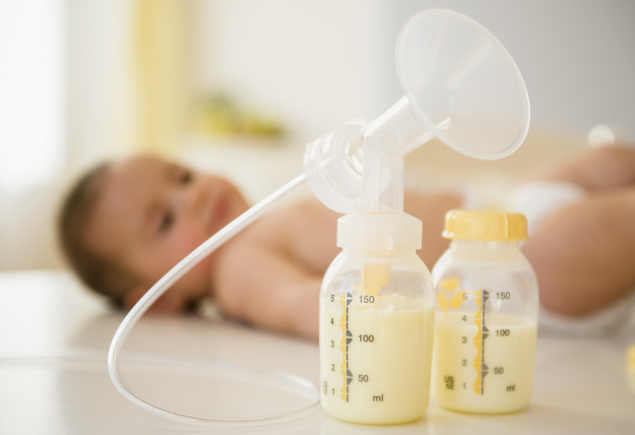 milk pumping materials next to a baby