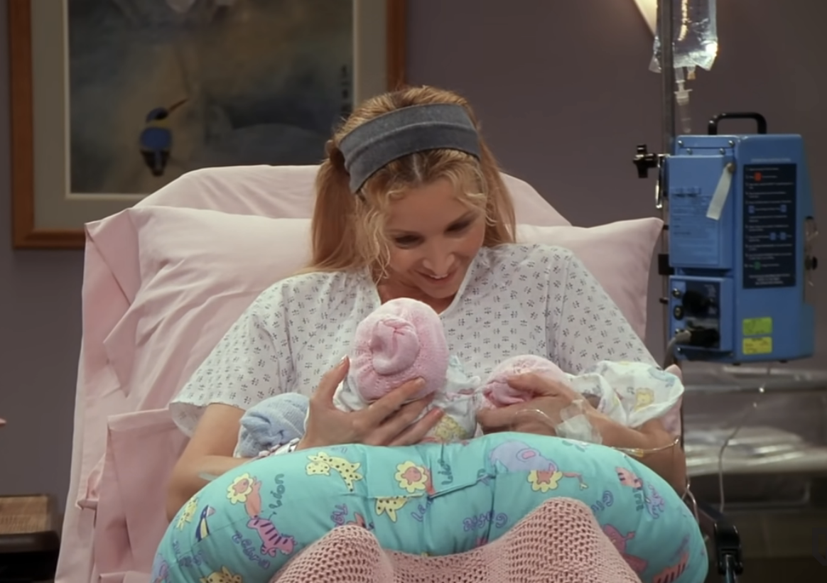 character holding newly born triplets