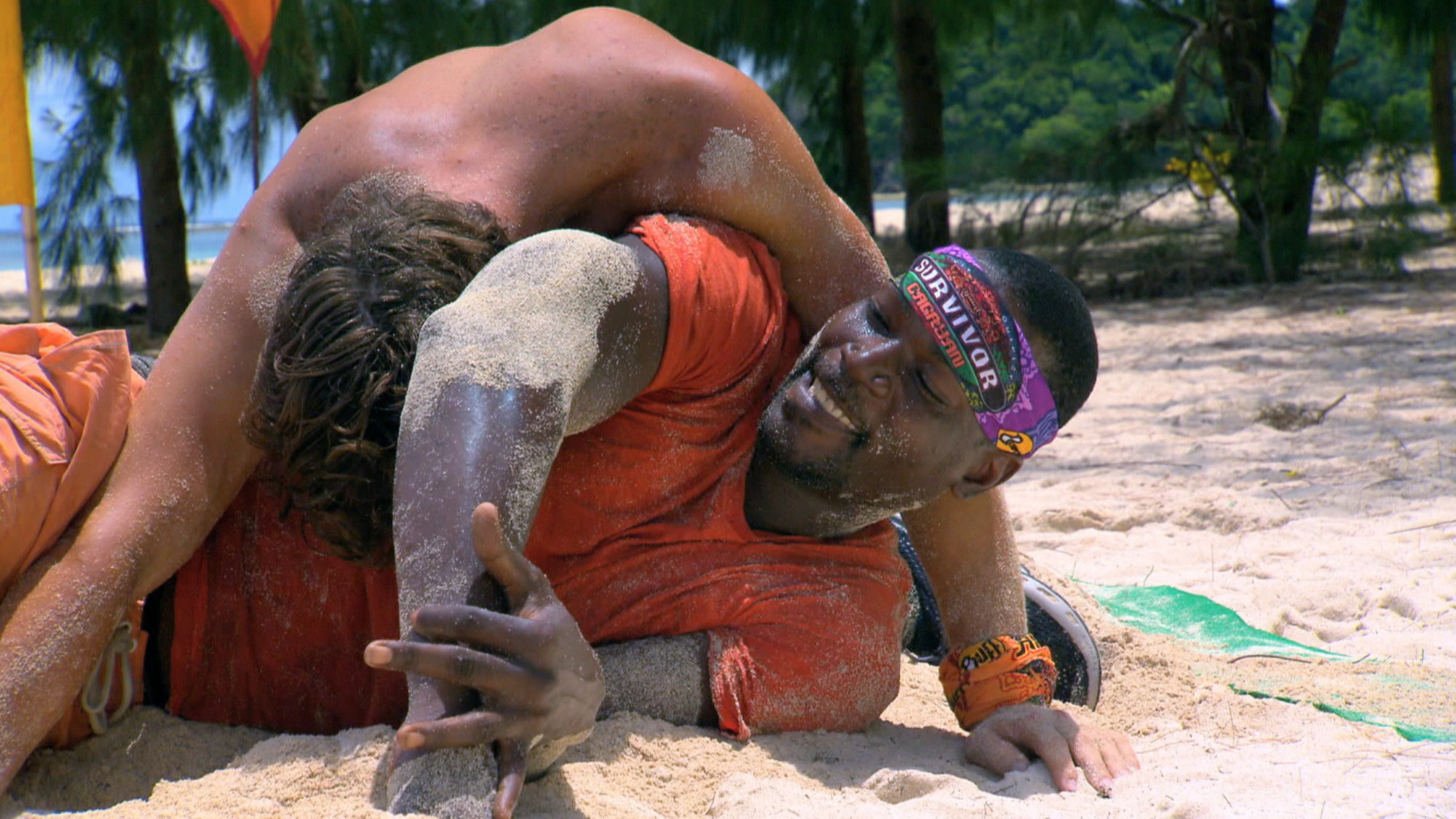 Cliff Robinson wrestles in the sand