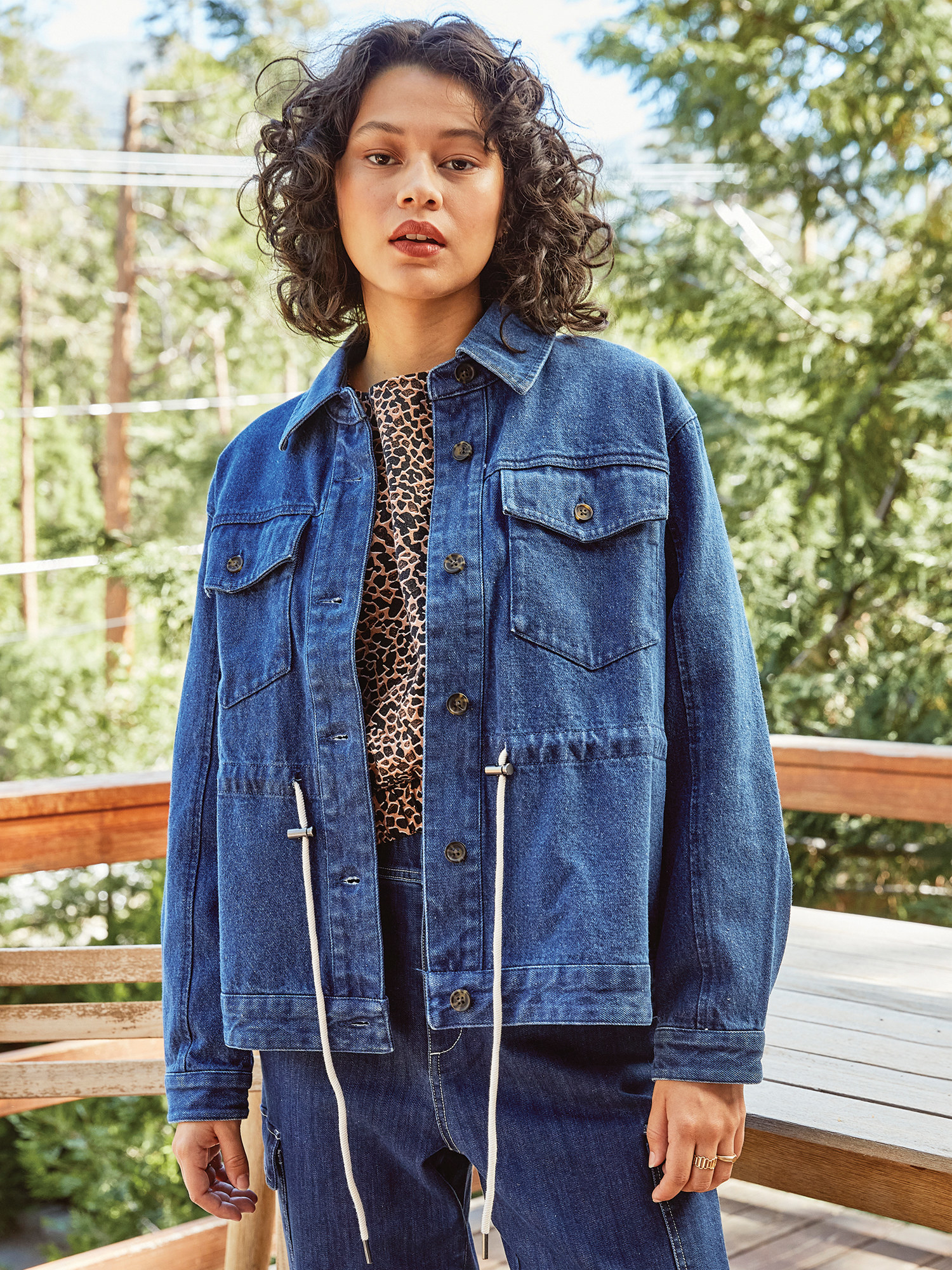 Model wearing denim jacket with midsection drawstring