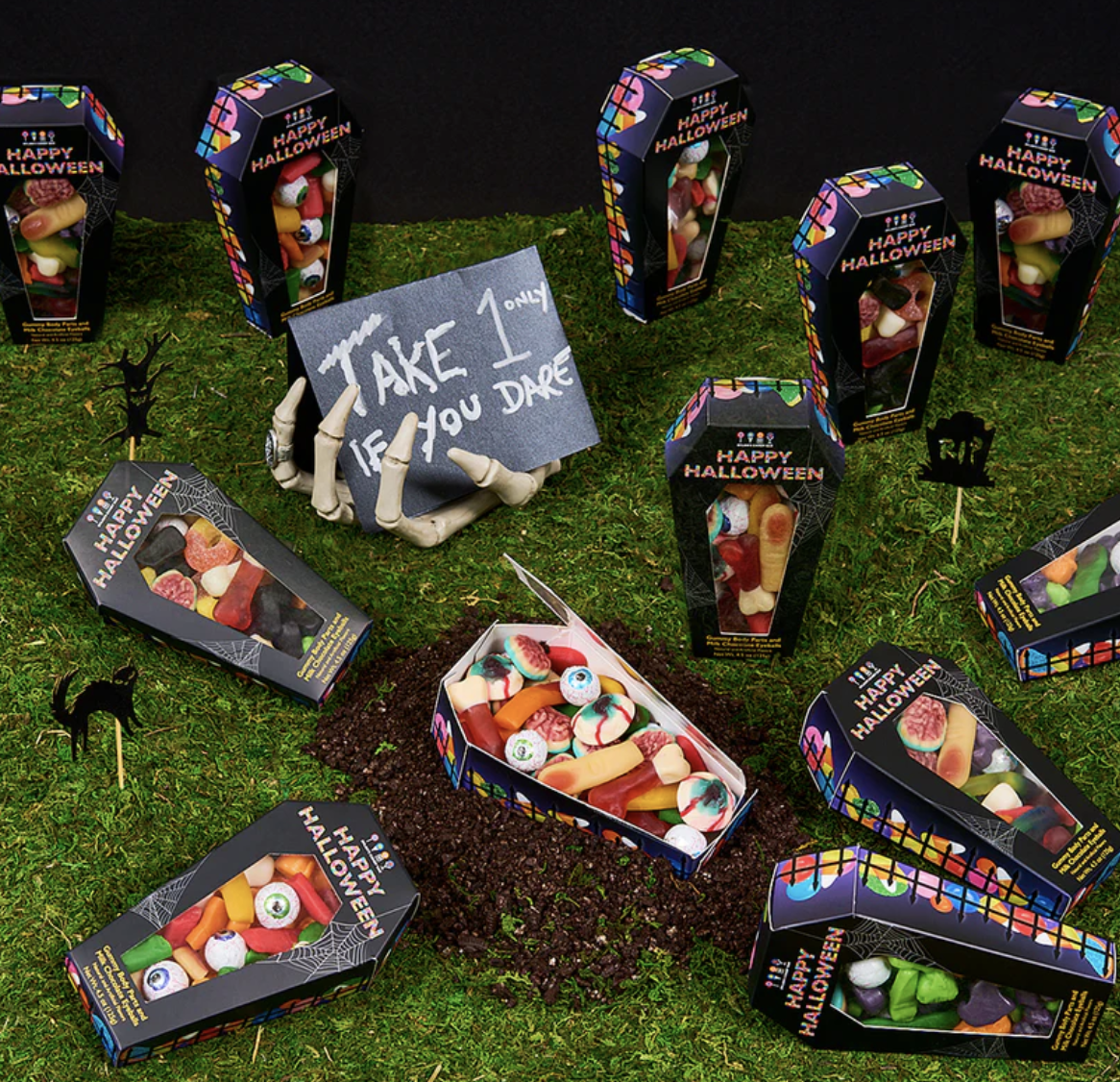 creepy candy coffins all over grass with gummy candies inside