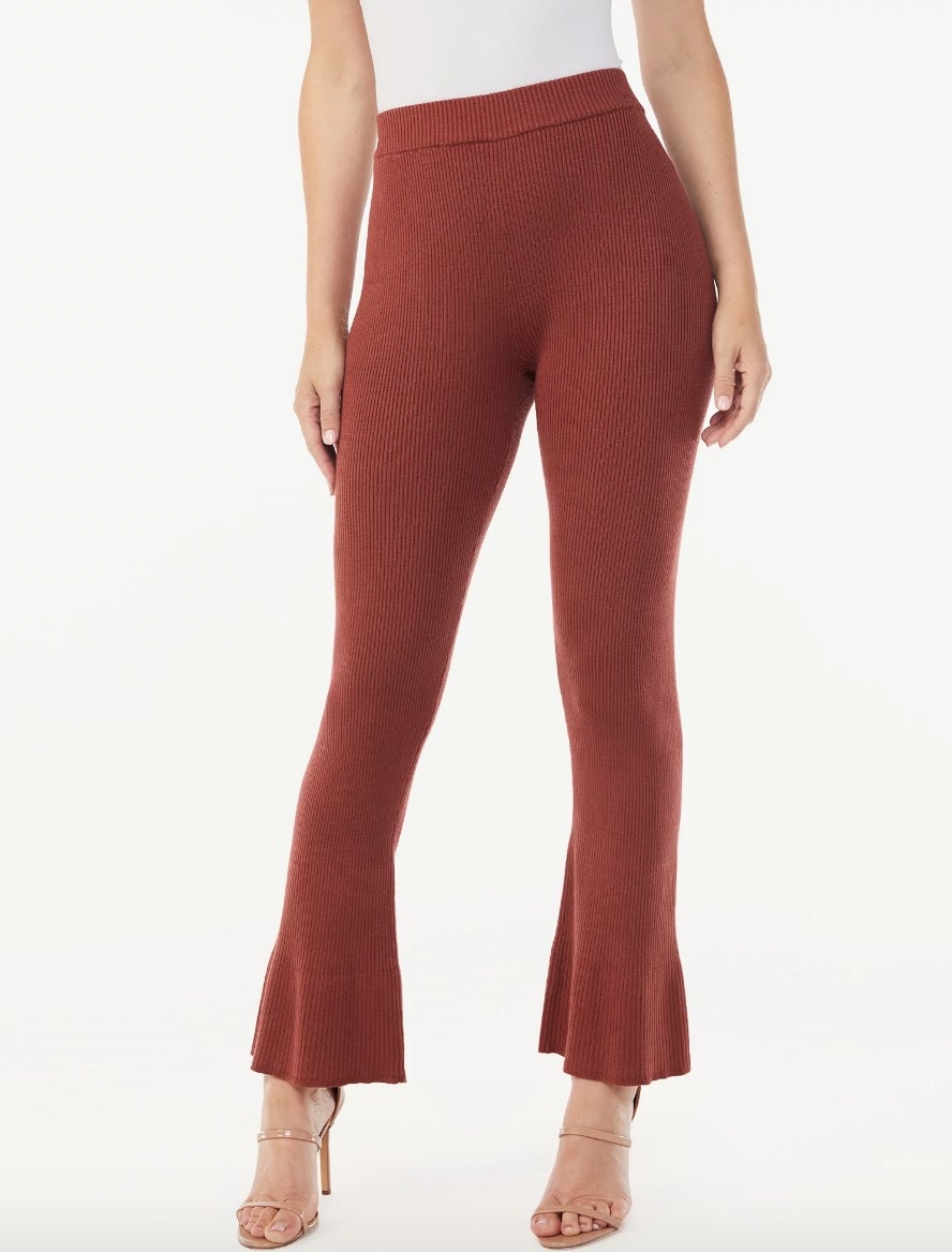 Model wearing burnt orange ribbed-knit flare pants