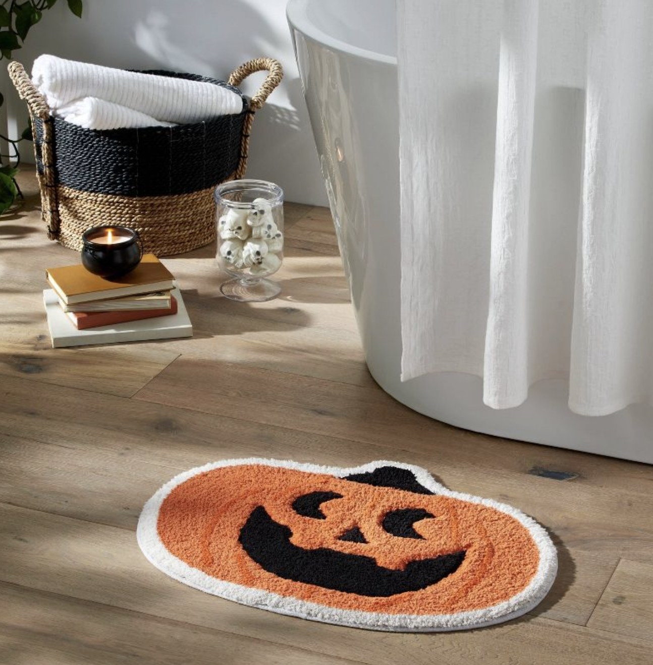The pumpkin bath rug in front of shower