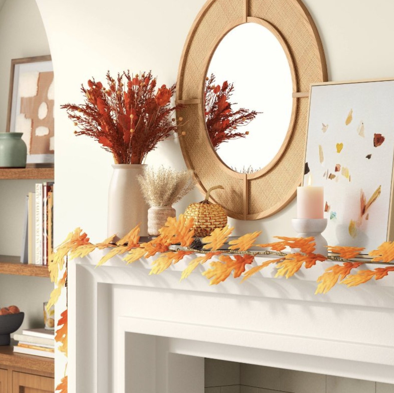 The orange and yellow artificial leaves garland on mantlepiece