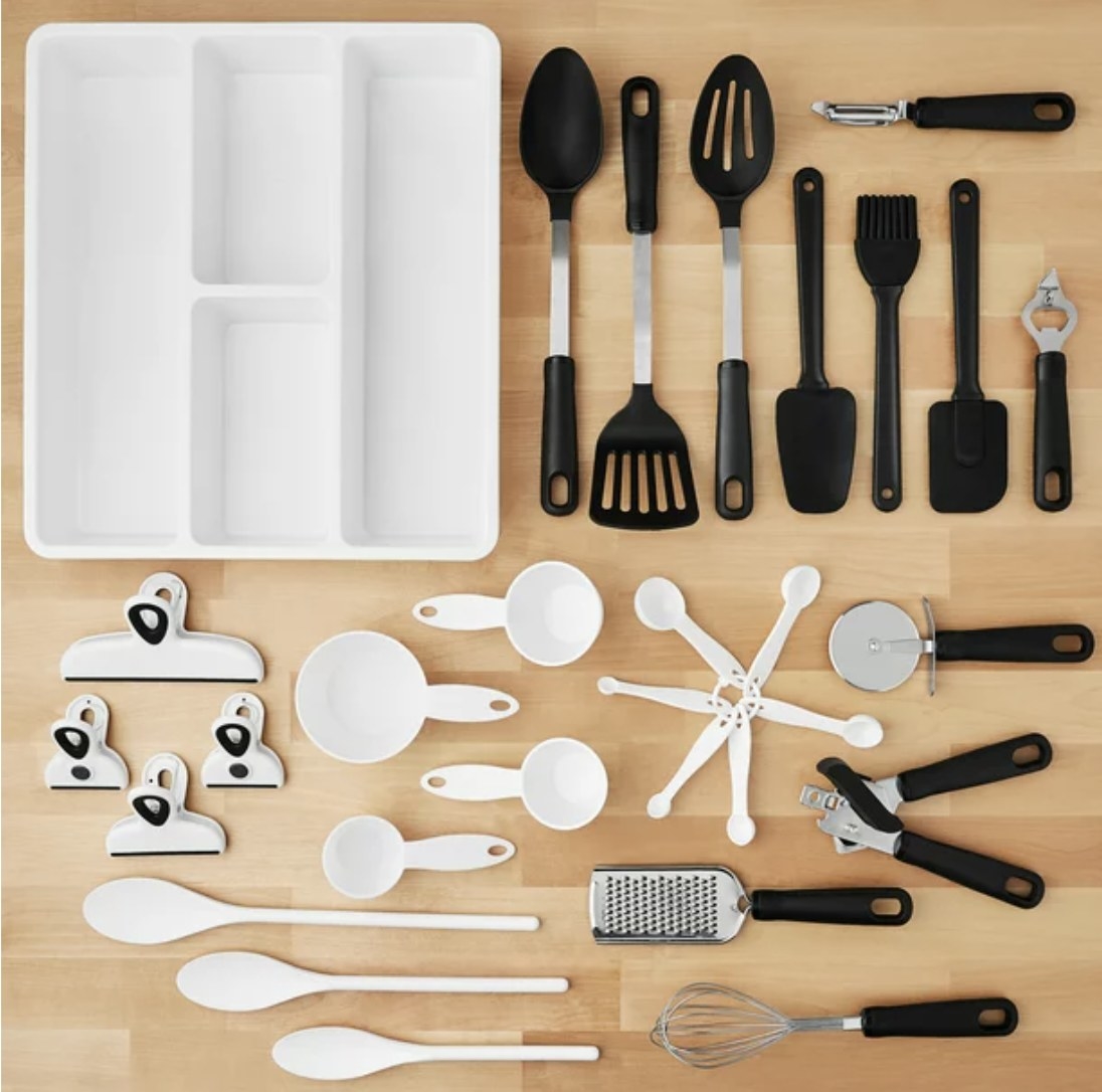 The set comes with various kitchen and organizational utensils in black, white and silver