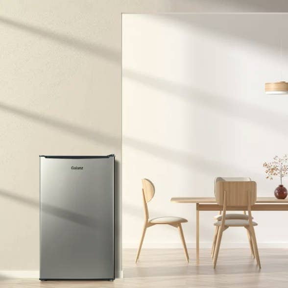 The silver fridge is an open room with natural lighting