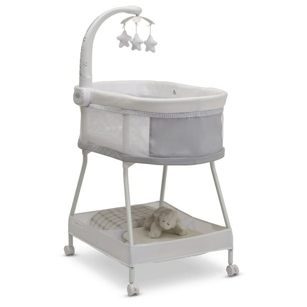 The white bassinet with a mobile featuring hanging star toys