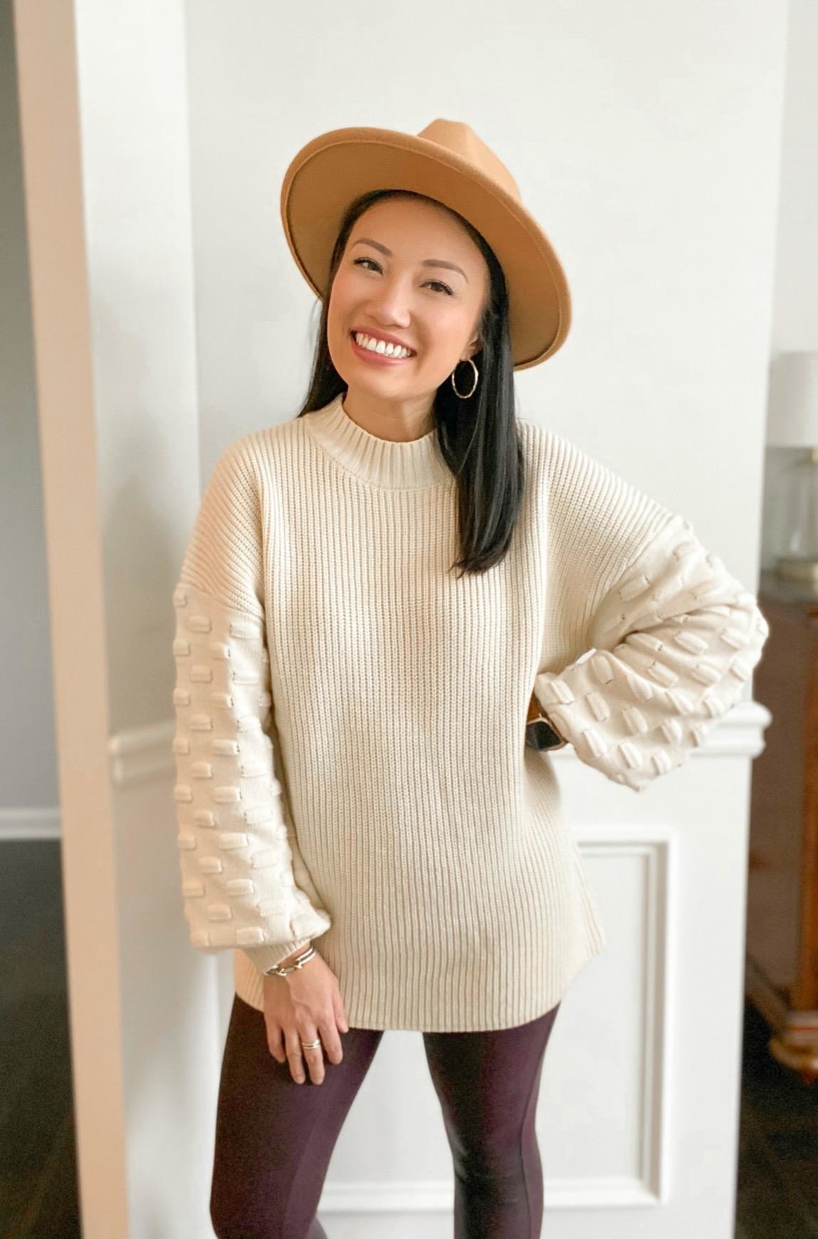 Reviewer wearing off-white sweater and leggings