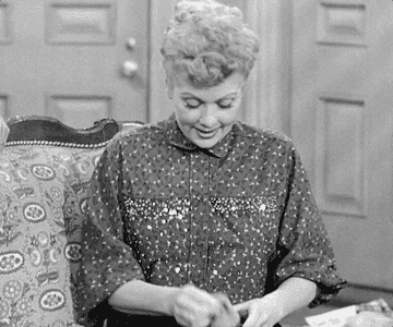Lucy from I love Lucy taking out a sock and being disappointed that nothing came out of it