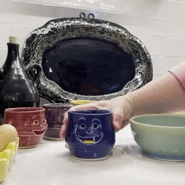 a gif of the owner using the navy cup