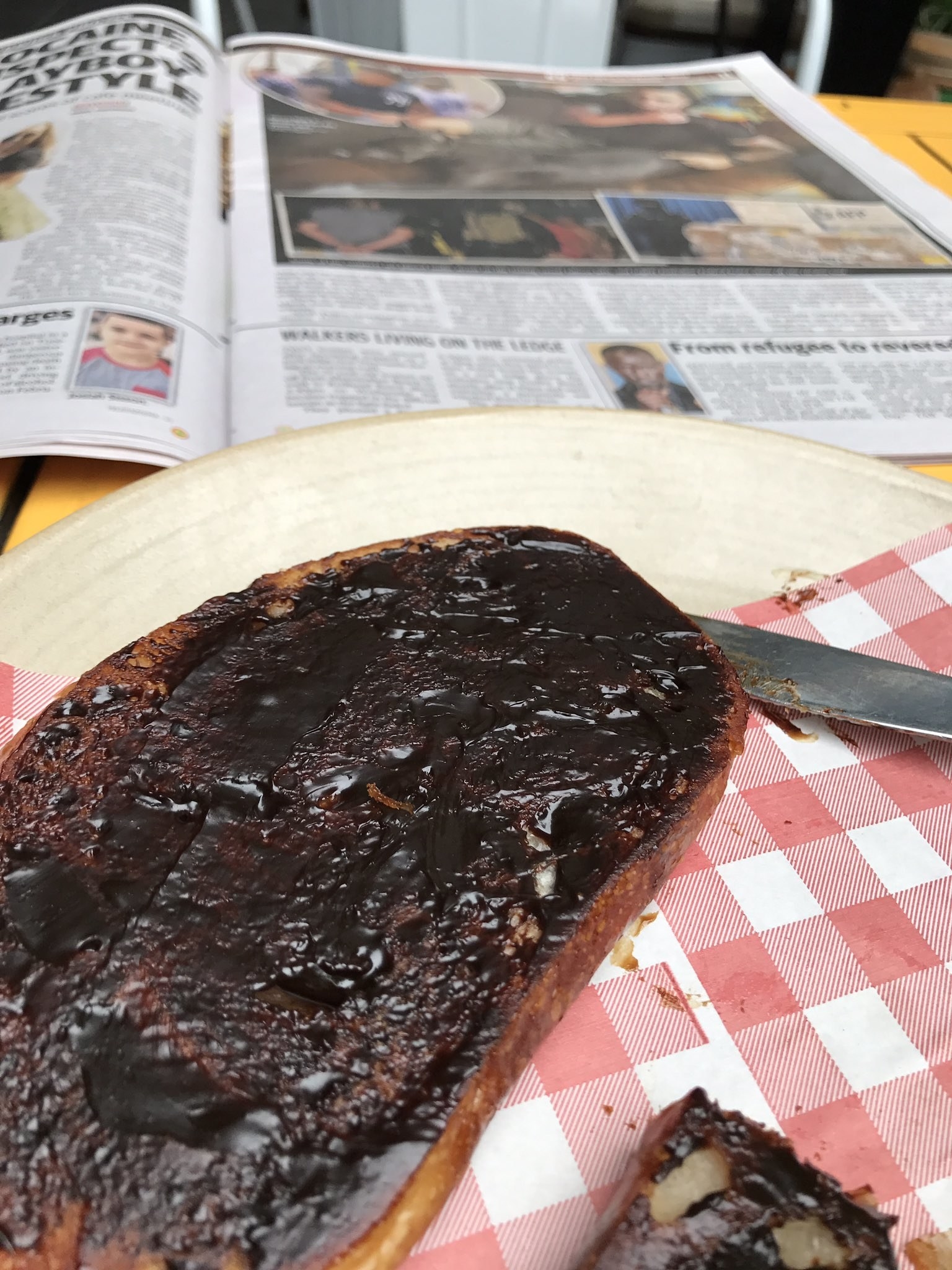 A plate of Vegemite toast which is VERY thickly spread