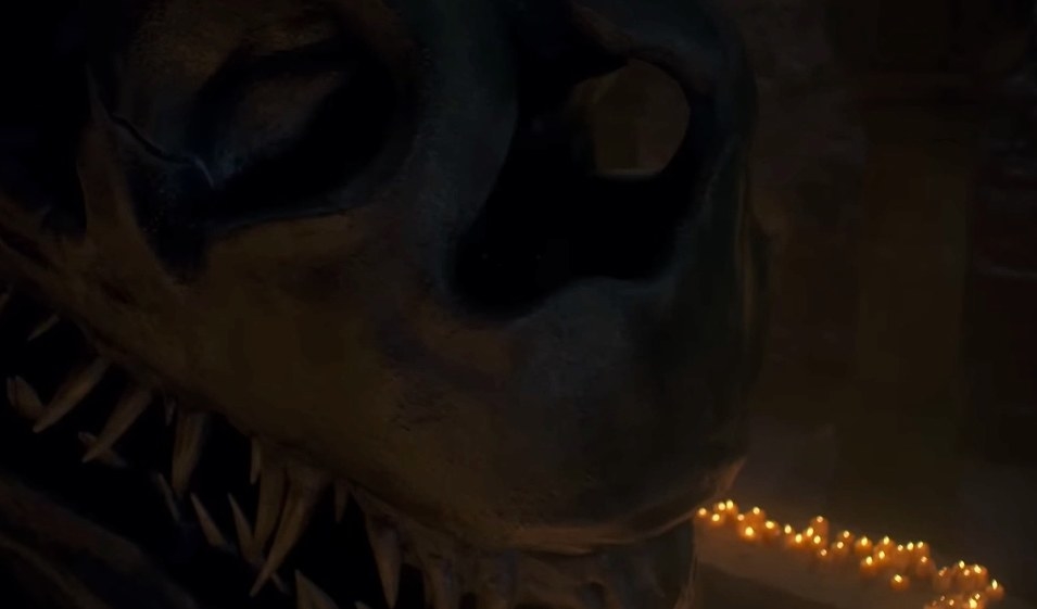 Balerion&#x27;s skull surrounded by candles, with someone moving in the shadows