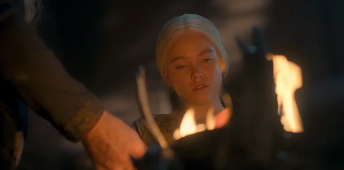 Rhaenyra looks at the dagger as Viserys holds it in a flame