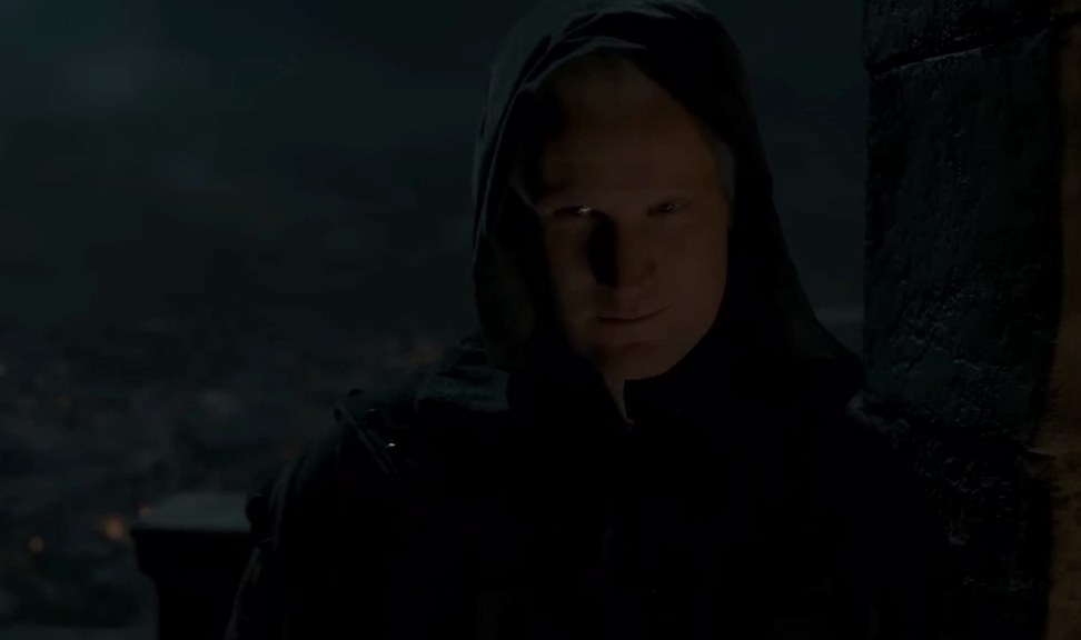 Daemon wears a dark hood with a mischievous look on his face