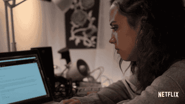 A woman crying at her laptop