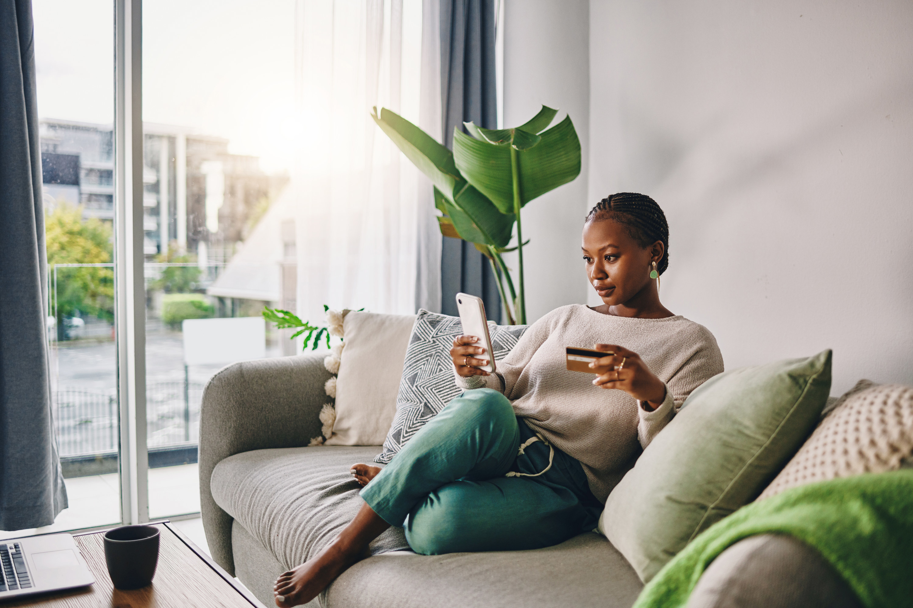 Woman on the couch looks up something on her phone