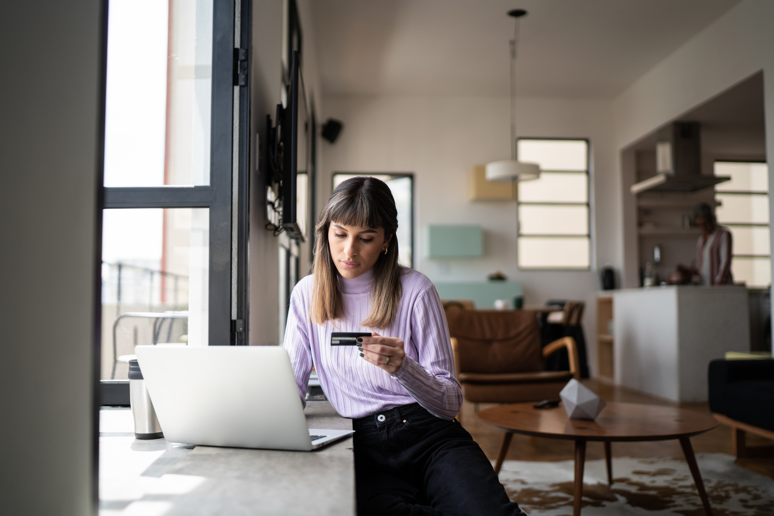 Woman buying something with her credit card online