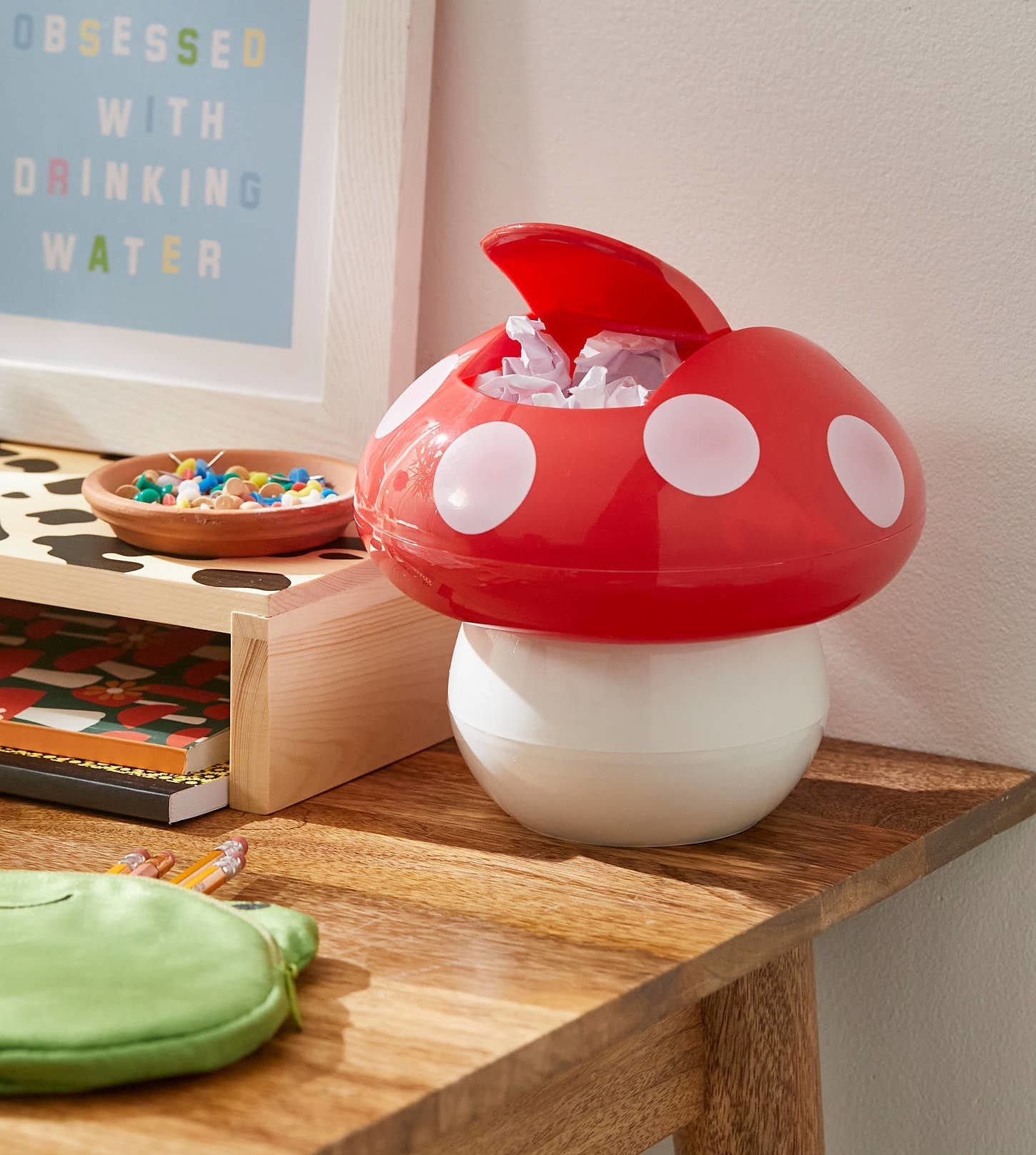 a mushroom-shaped trash bin on a desk