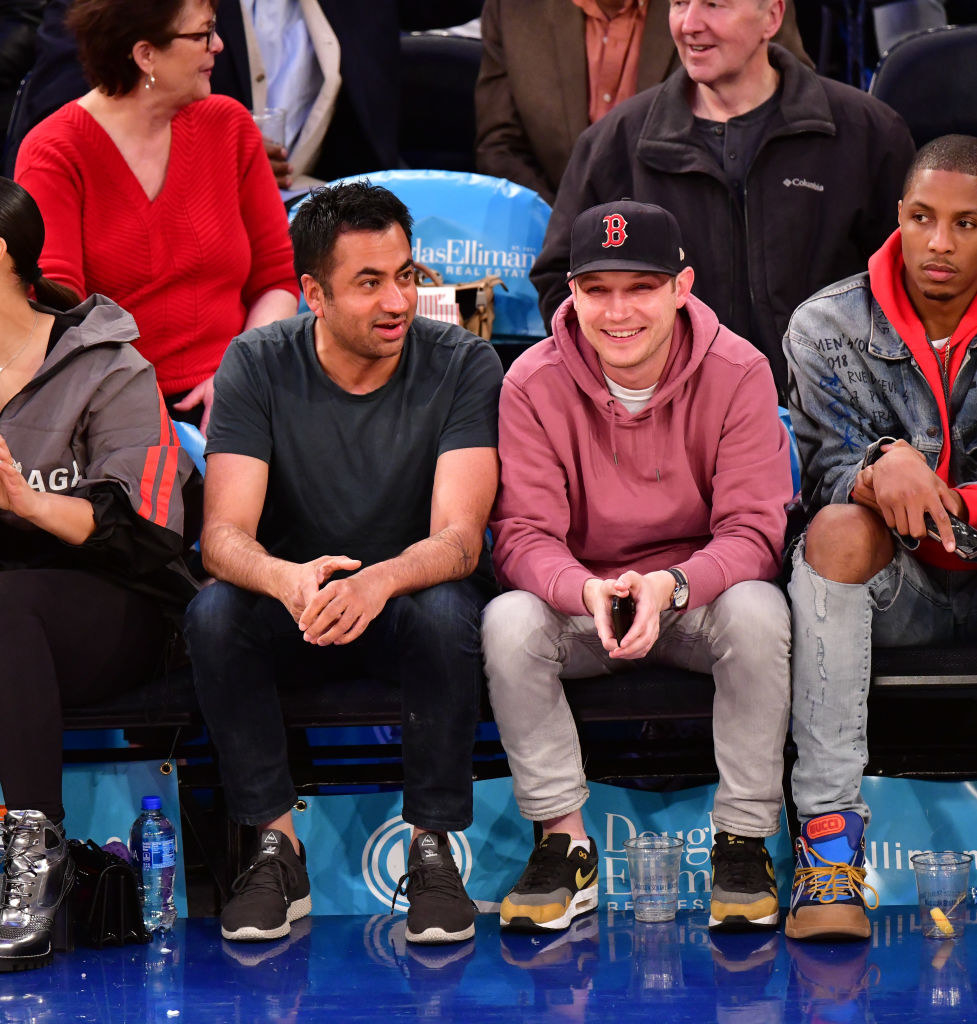 Kal Penn sits next to his fiancé, Josh, at a basketball game