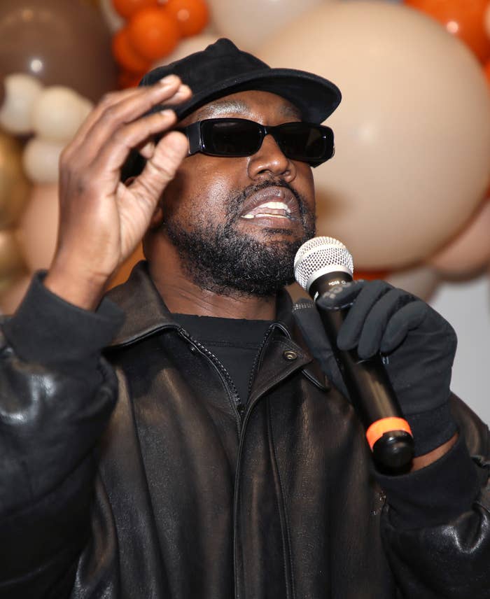 A close-up of Kanye speaking into a mic