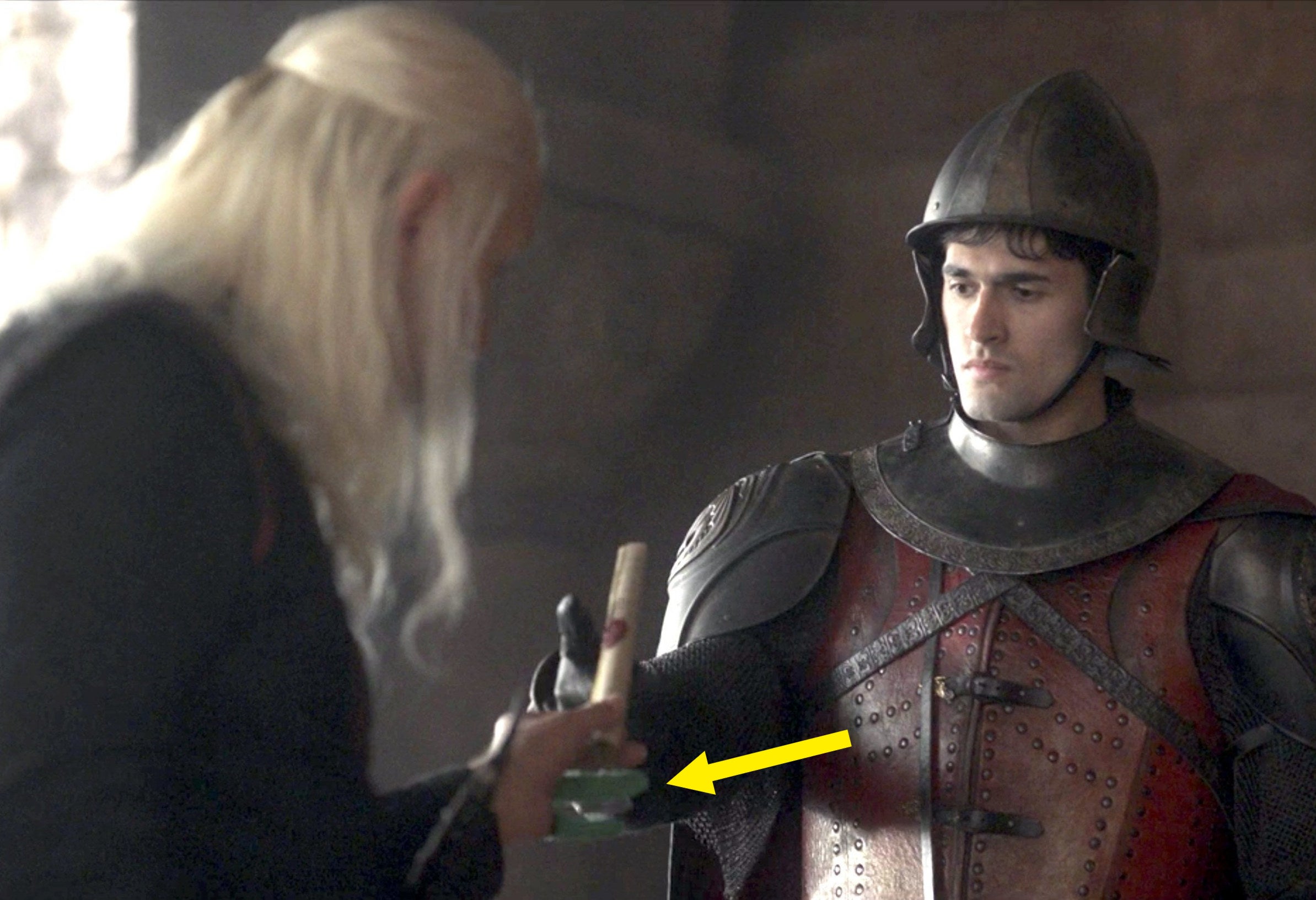 King Viserys holds a scroll but the actor is wearing green screen material on two of his fingers