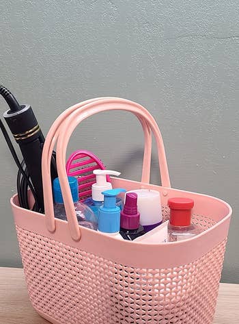 reviewer's shower caddy filled with products