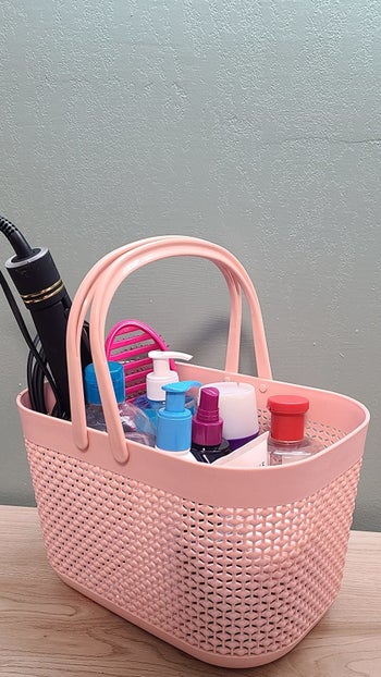 reviewer's shower caddy filled with products