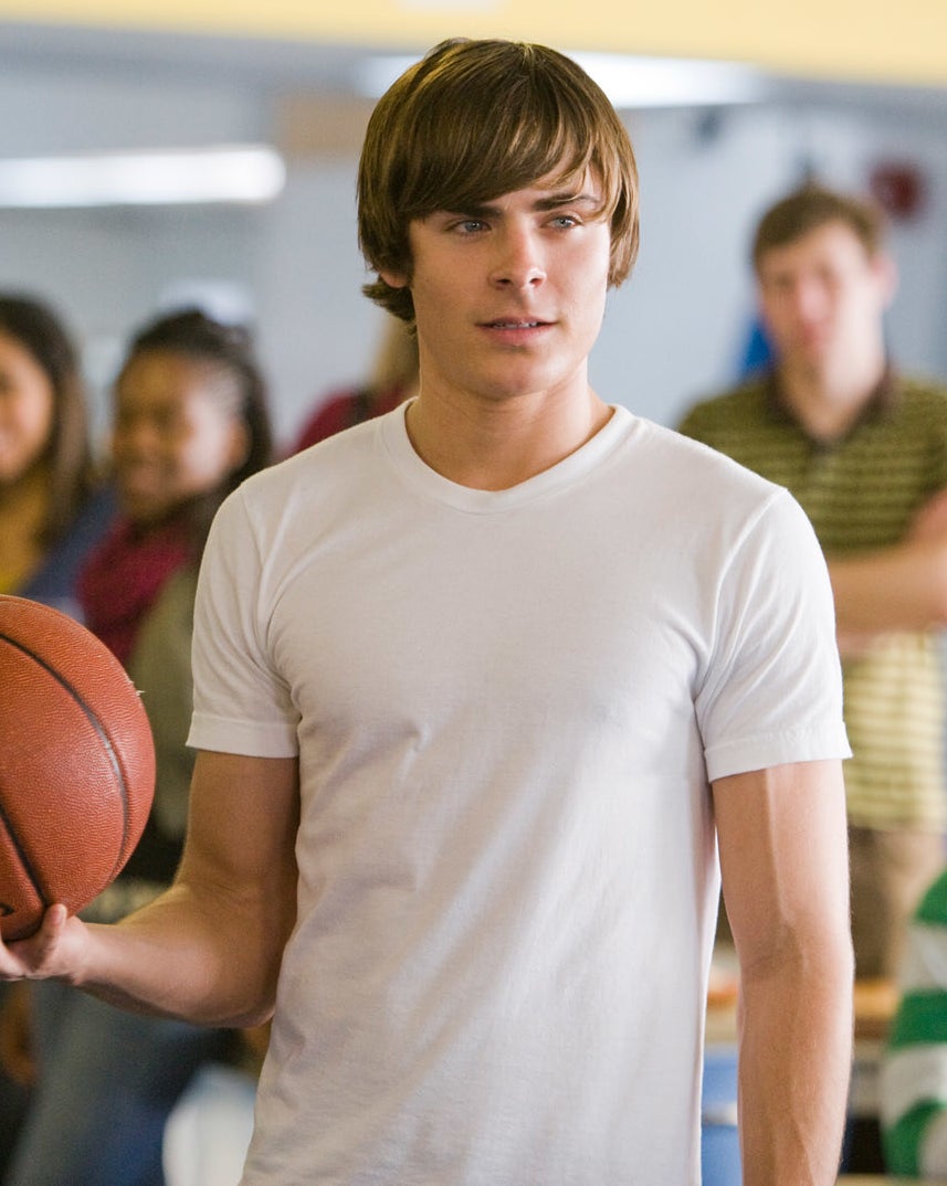 Zac in a short-sleeved T-shirt and holding a basketball